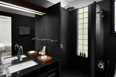 a black bathroom with a sink and a mirror at Tropical 3BR Holiday Villa with Pool, BBQ, and Shaded Patio within Walking Distance to Bang Tao Beach in Bang Tao Beach