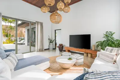 a living room with white furniture and a flat screen tv at Tropical 3BR Holiday Villa with Pool, BBQ, and Shaded Patio within Walking Distance to Bang Tao Beach in Bang Tao Beach