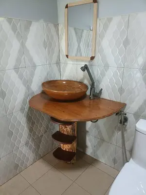 a bathroom with a wooden sink and a mirror at Baan I Ta Lay Koh Yao Noi in Ko Yao Noi