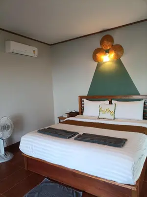 a bedroom with a large bed with a green ceiling at Baan I Ta Lay Koh Yao Noi in Ko Yao Noi