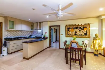 a kitchen with a table and a ceiling fan at Karon View Apartments in Karon Beach