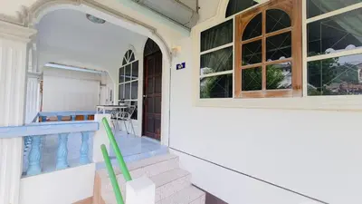 a porch of a house with a swimming pool at Karon House 15B in Karon Beach