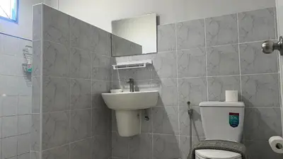 a bathroom with a sink and a toilet and a mirror at Karon house 15A in Karon Beach