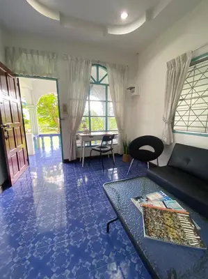 a living room with a couch and a table at Karon house 15A in Karon Beach