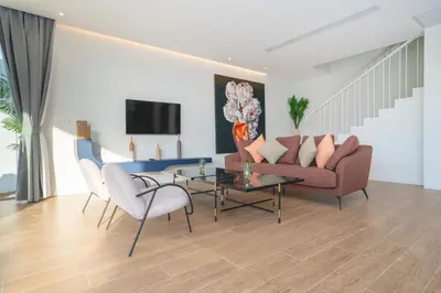 a living room with a couch and chairs and a table at Capucine Villas in Kamala Beach
