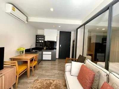 a living room with a couch and a table at The Deck patong Luxury Apartments The Deck patong in Patong Beach