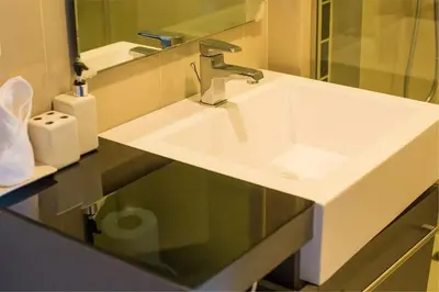 a white sink in a bathroom with a mirror at The Deck patong Luxury Apartments The Deck patong in Patong Beach