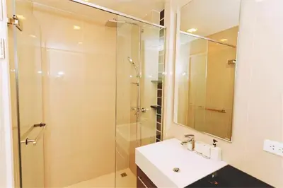 a bathroom with a sink and a glass shower at The Deck patong Luxury Apartments The Deck patong in Patong Beach