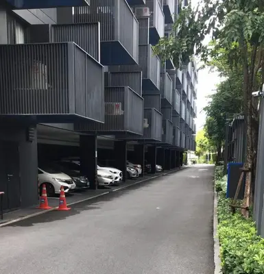 an empty street with cars parked next to a building at The Deck patong Luxury Apartments The Deck patong in Patong Beach