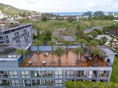 an aerial view of a building with palm trees at Suite Celeste 1BR Sunset RooftopCitygate Kamala in Kamala Beach