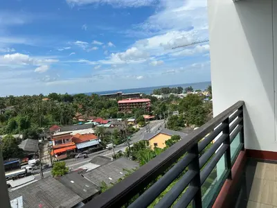 a view of a city from a balcony at Phuket Condominium Karon beach in Karon Beach