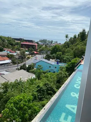 a swimming pool with a view of a city at Phuket Condominium Karon beach in Karon Beach