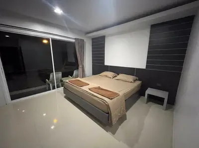 a bedroom with a bed and a large window at PP Midnight Hotel in Phi Phi Don