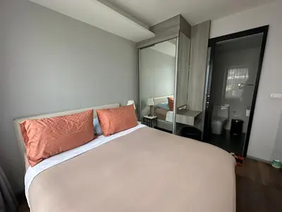 a bedroom with a bed with two pillows on it at Phuket apartment surin beach in Thalang