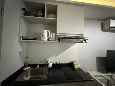 a kitchen with a sink and a counter top at Phuket apartment surin beach in Thalang