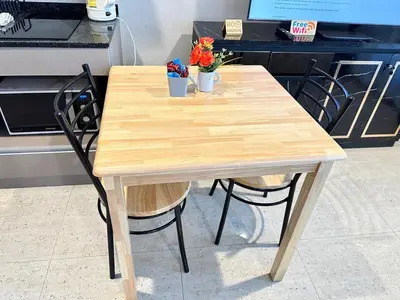a wooden table with two pots of flowers on it at Phuket apartment surin beach in Thalang