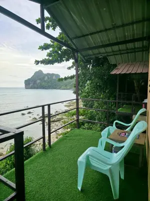 two chairs sitting on a porch overlooking the ocean at Phi Phi Seaside Bungalow in Phi Phi Don
