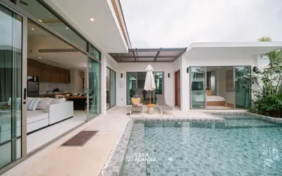 an indoor pool in a villa with a living room at Villa Alanna Phuket in Bang Tao Beach