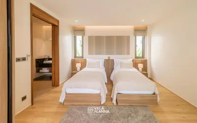 a bedroom with three beds in a room at Villa Alanna Phuket in Bang Tao Beach