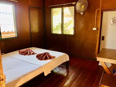 a bedroom with a bed with two pillows on it at JR GYM & Resort in Phi Phi Don