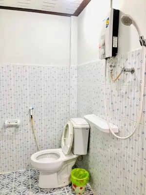a bathroom with a toilet and a shower at JR GYM & Resort in Phi Phi Don