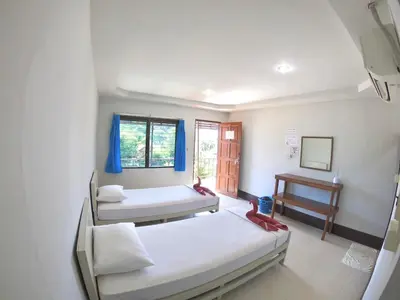 a hospital room with two beds and a table at JR GYM & Resort in Phi Phi Don