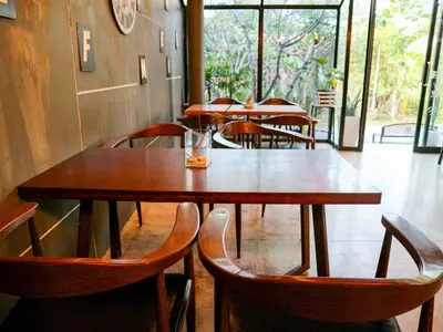a row of tables and chairs in a restaurant at Z&Z Resort in Rawai Beach