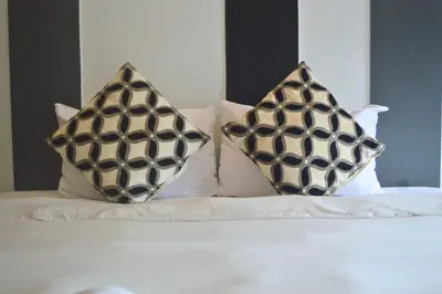 two pillows sitting on top of a bed at Z&Z Resort in Rawai Beach