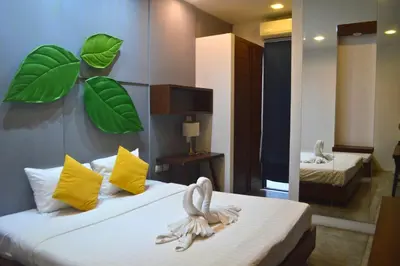 a hotel room with a bed with towels on it at Z&Z Resort in Rawai Beach
