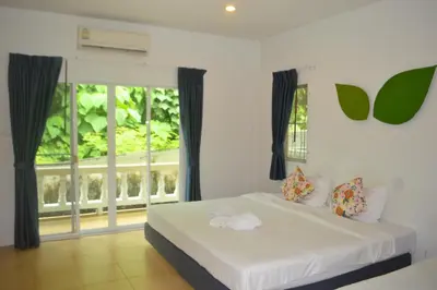 a bedroom with a bed and a large window at Z&Z Resort in Rawai Beach