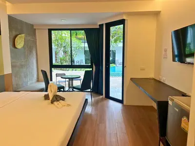 a hotel room with a bed and a living room at Z&Z Resort in Rawai Beach