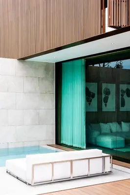 a white couch in front of a building at Mono Oxygen Modern Pool Villas- Bangtao Beach in Phuket Town