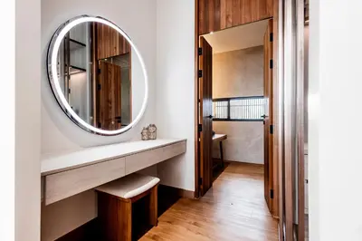 a bathroom with a round mirror and a sink at Mono Oxygen Modern Pool Villas- Bangtao Beach in Phuket Town