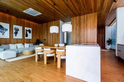 a living room with a table and a couch at Mono Oxygen Modern Pool Villas- Bangtao Beach in Phuket Town