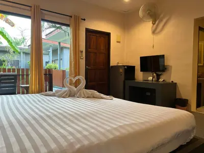 a bedroom with a bed with a heart decoration on it at ViVi Hotel Resort in Phuket Town
