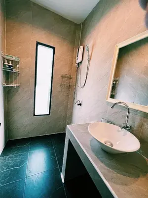 a bathroom with a sink and a window at ViVi Hotel Resort in Phuket Town