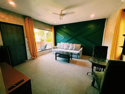 a living room with a couch and a table at ViVi Hotel Resort in Phuket Town