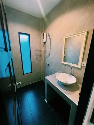 a bathroom with a sink and a shower at ViVi Hotel Resort in Phuket Town