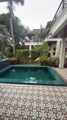 a swimming pool in the courtyard of a building at Tropical garden in Phuket Town