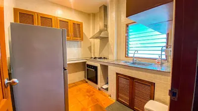 a kitchen with a refrigerator and a sink at Tropical garden in Phuket Town