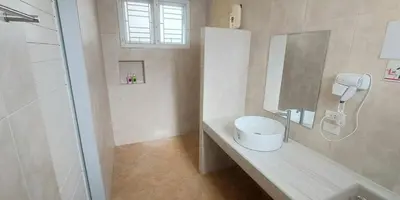 a bathroom with a sink and a phone on a counter at Udomsuk villa phuket in Bang Tao Beach