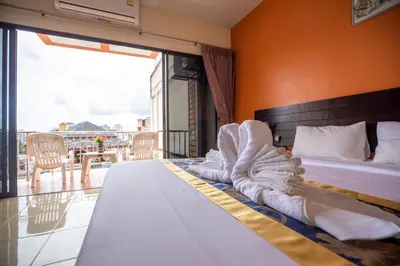 a hotel room with a bed with towels on it at Lily Holiday hotel \u767e\u5408\u5047\u65e5\u9152\u5e97 in Patong Beach