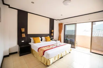 a bedroom with a large bed and a large window at Lily Holiday hotel \u767e\u5408\u5047\u65e5\u9152\u5e97 in Patong Beach