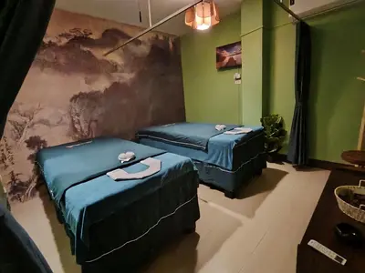 two beds in a room with green walls at Lily Holiday hotel \u767e\u5408\u5047\u65e5\u9152\u5e97 in Patong Beach