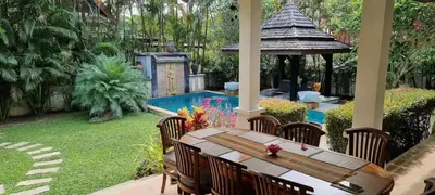 a patio with a table and chairs next to a pool at Wonderful Villa in Rawai with Private Pool in Rawai Beach
