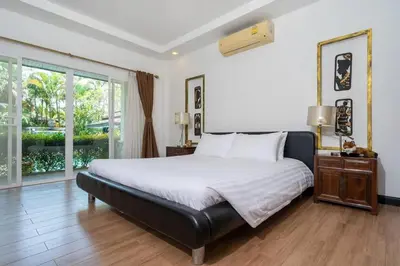 a bedroom with a large bed and a large window at Wonderful Villa in Rawai with Private Pool in Rawai Beach