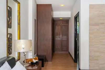 a hallway with a door and a table with a lamp at Wonderful Villa in Rawai with Private Pool in Rawai Beach