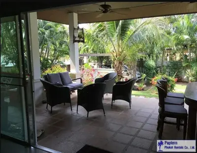 a patio with a bunch of chairs and a table at Wonderful Villa in Rawai with Private Pool in Rawai Beach