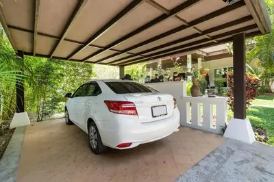 a white car parked under a pergola at Wonderful Villa in Rawai with Private Pool in Rawai Beach