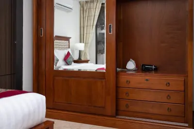 a bedroom with a mirror and a dresser at Nai Harn Beach Condominium in Nai Harn Beach